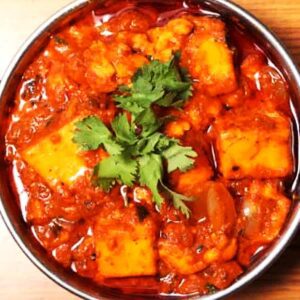 "Enjoy our Kadai Paneer: Soft paneer cubes sautéed with a colorful medley of bell peppers, onions, and a blend of aromatic spices,